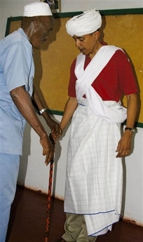 U.S. Senator Barack Obama, right, is dressed as a Somali Elder by Sheikh Mahmed Hassan, left, during his visit to Wajir, a rural area in northeastern Kenya, near the borders with Somalia and Ethiopia. The area is at the epicenter of a severe drought that has hit the Horn of Africa region, after erratic and insufficient rains during the April-June season.